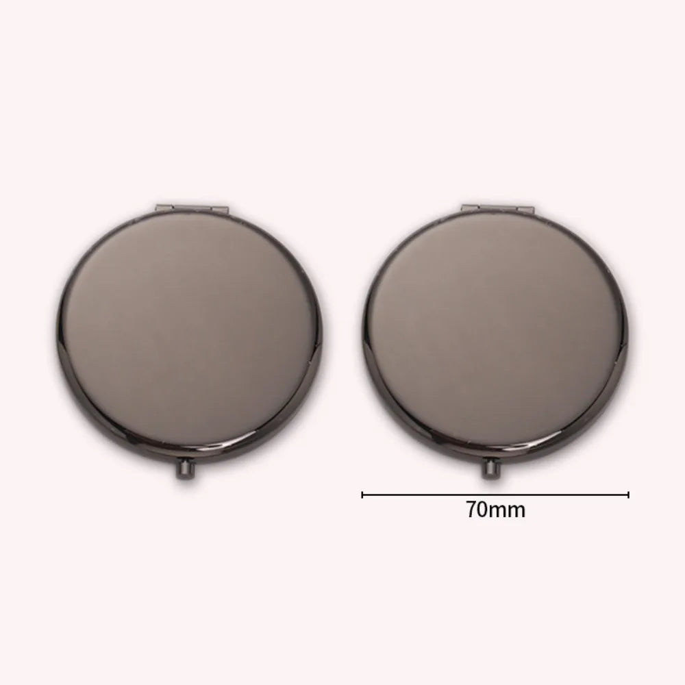 A round, portable folding makeup mirror with a magnifying feature shown from the top.