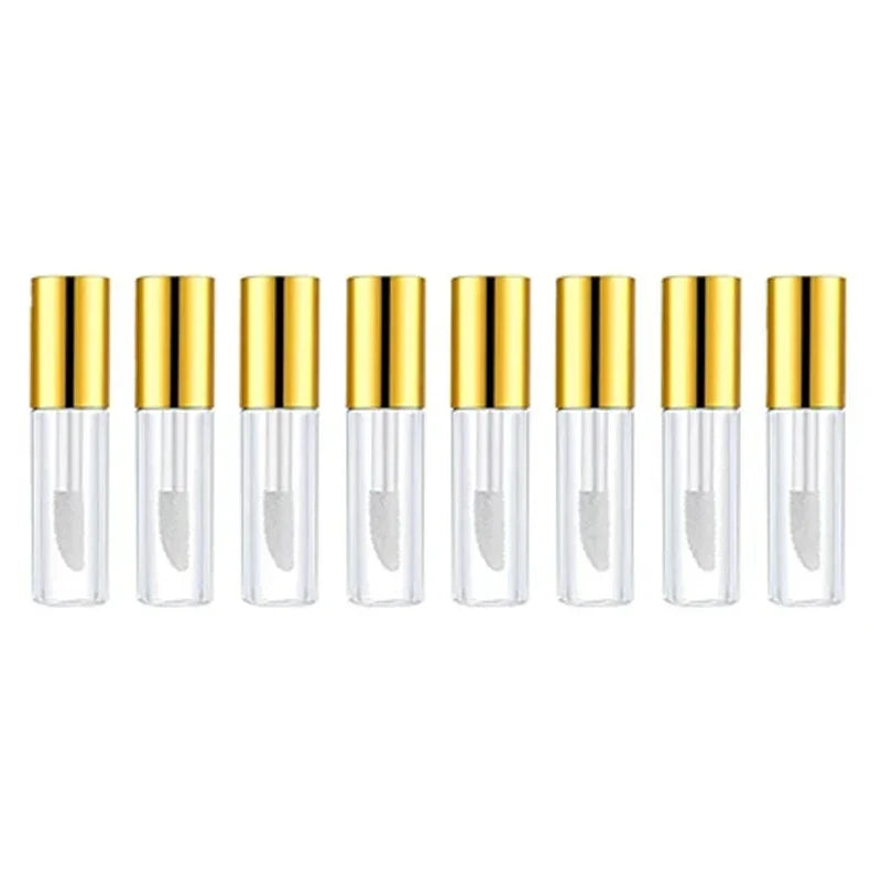 A row of twelve empty clear lip gloss tubes with gold caps arranged horizontally.