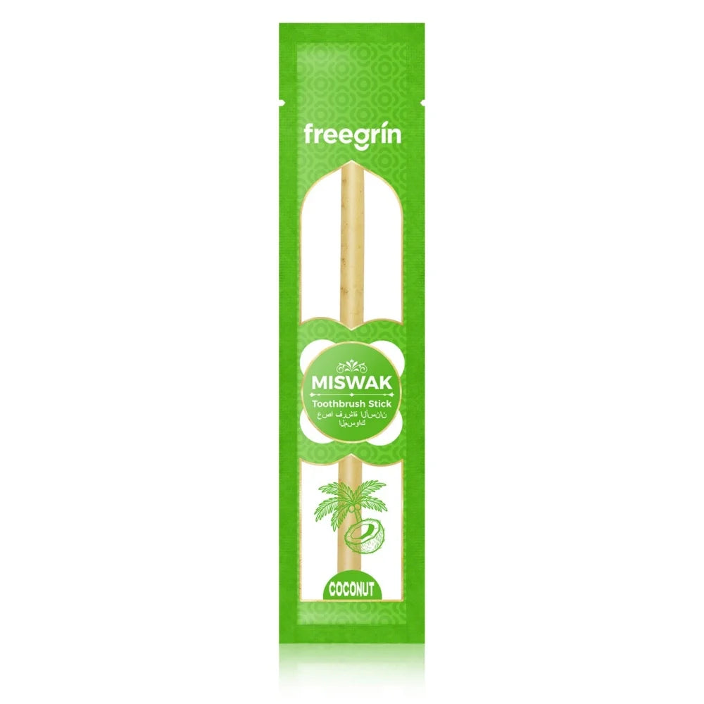 A green package of Miswak toothbrush sticks with a wooden stick inside.