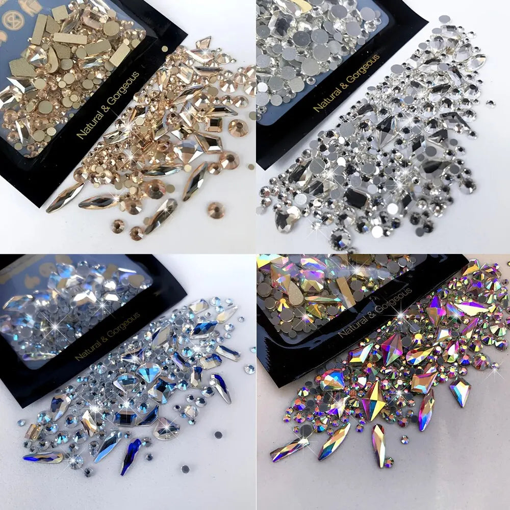 A collection of mixed glass rhinestones in various silver and gold tones displayed on a black background.