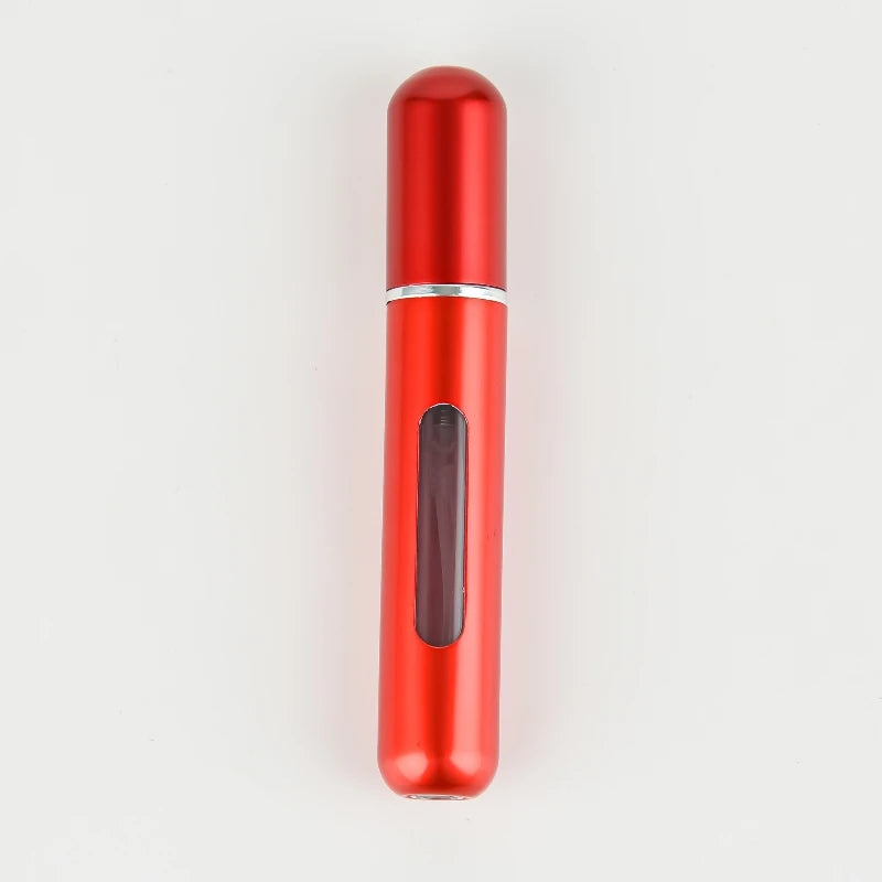 A red, cylindrical portable refillable perfume bottle with a silver band and a clear glass insert.
