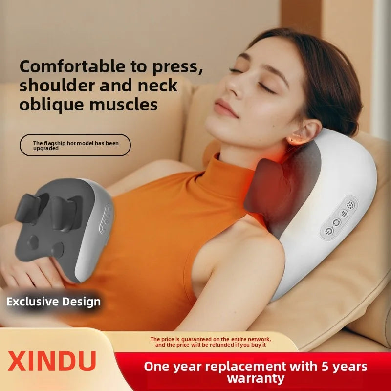 A woman is using a white shiatsu neck massager pillow on her shoulder and neck while relaxing.