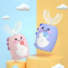 A purple kids sonic electric toothbrush with a timer and music is shown against a light blue background with white clouds.