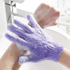 A hand wearing a purple exfoliating mitt is shown under a faucet, demonstrating the product for body massage.