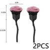 A pair of pink and black nail art dust brushes shown with a scale for size reference.