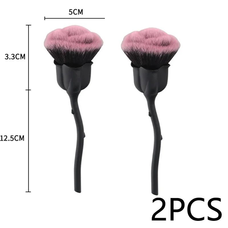 A pair of pink and black nail art dust brushes shown with a scale for size reference.