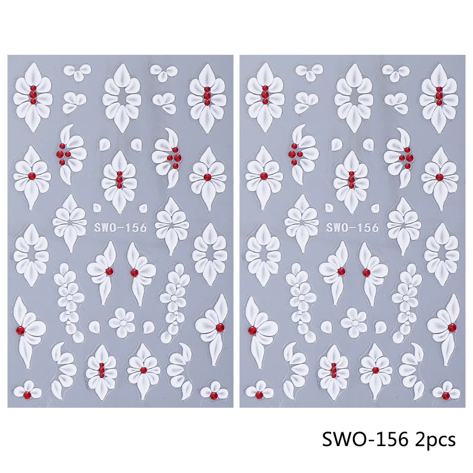 A set of two embossed white floral nail stickers featuring various flower shapes and accents on a light gray background.