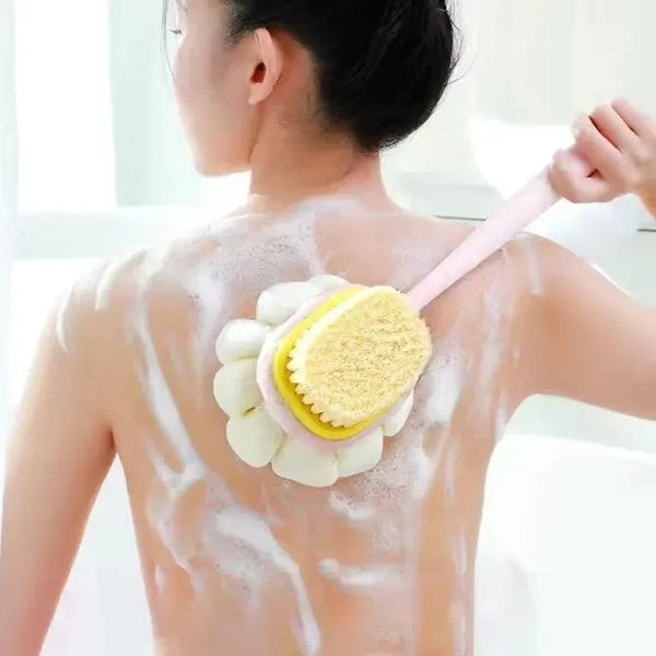 A person is using a long-handle loofah back scrubber with a soft mesh sponge on their back.