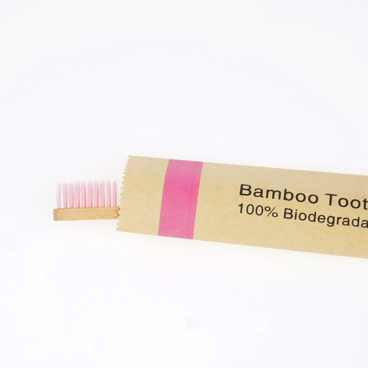 A package of bamboo toothbrushes with pink bristles and a label indicating 100% biodegradable.