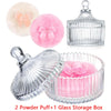 A set of two pink velvet powder puffs and one clear glass storage box for cosmetics.