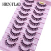 Plateau en plastique rose contenant plusieurs rangées de faux cils de renard noirs pour application.