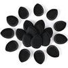 A collection of black makeup sponge puffs scattered on a white background.
