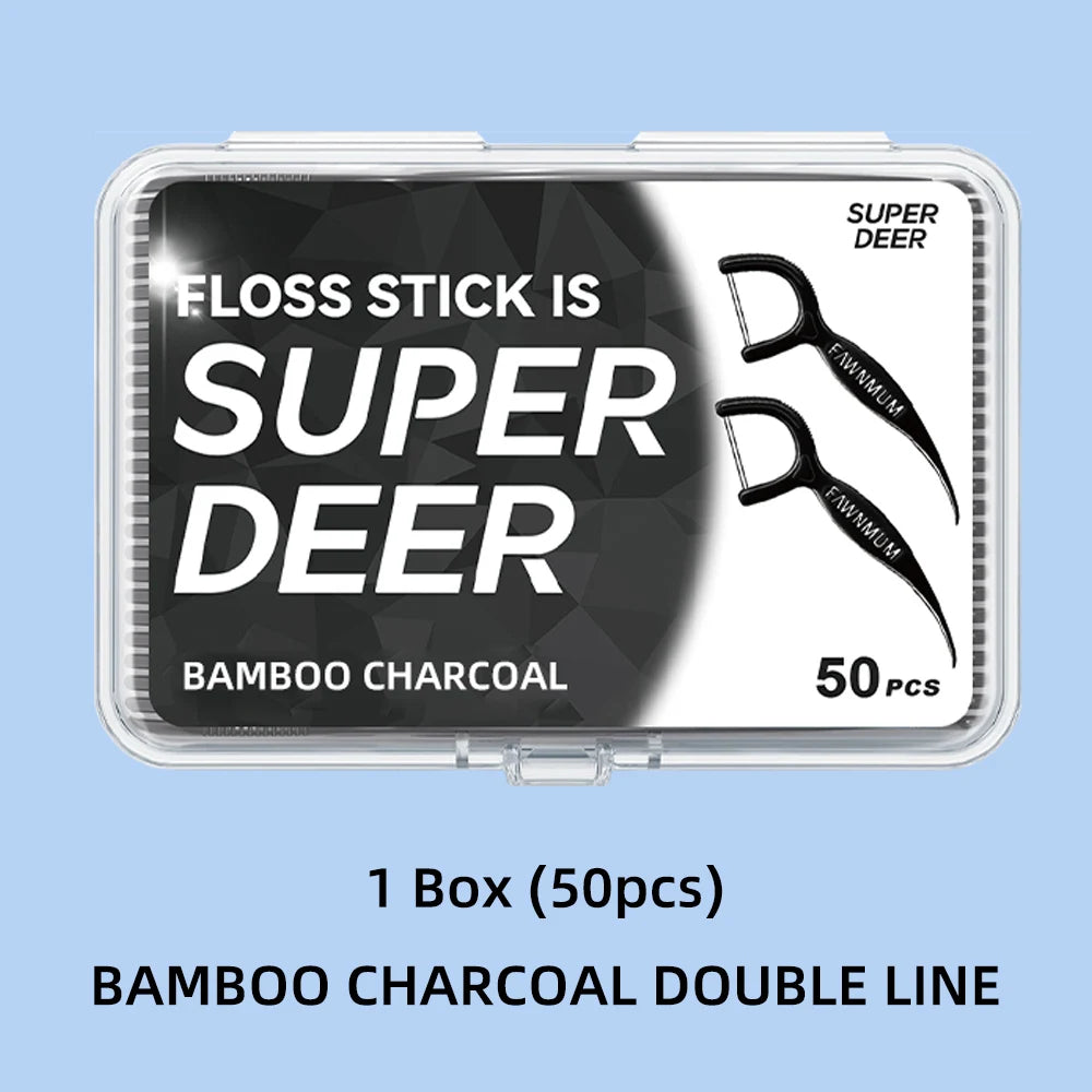 A box of super deer bamboo charcoal double line floss sticks with a scissor-like applicator visible.