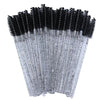 A set of disposable eyelash and eyebrow brushes with black bristles and silver handles.