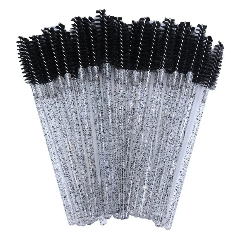 A set of disposable eyelash and eyebrow brushes with black bristles and silver handles.