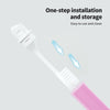 Une brosse à dents mini pliable rose, avec une flèche indiquant l'installation ou le rangement.