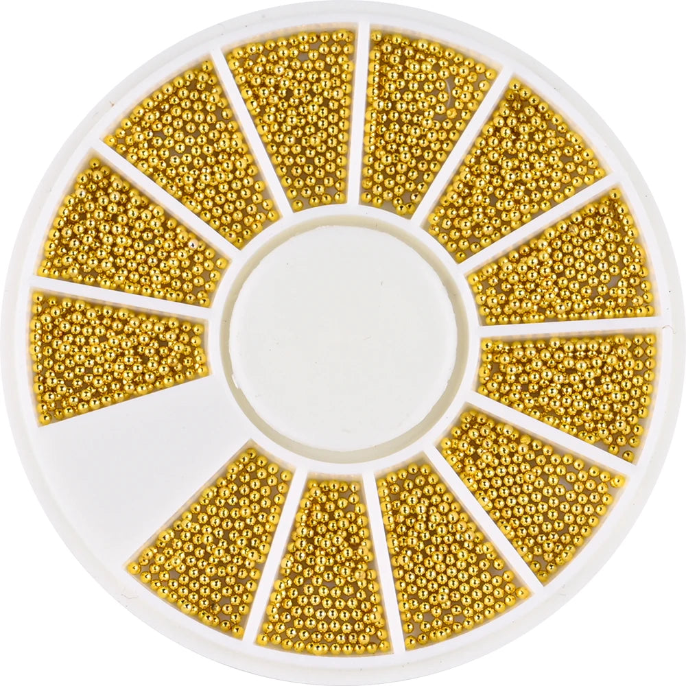 A circular plate filled with gold mixed stainless steel beads arranged in radiating triangular sections for nail art decorati