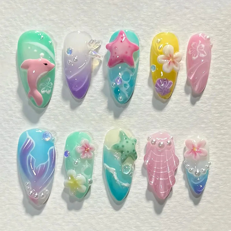A set of 8 press-on nails featuring gradient blue and pink colors with starfish and floral designs.
