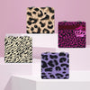 Three portable makeup mirrors featuring leopard print designs in black, beige, and purple.
