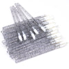 A collection of crystal lip brushes and lash spoolies arranged in a rectangular bundle.