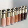 A row of liquid bronzer contour foundation sticks in various shades lined up on a white surface.