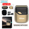 A gold-colored electric foil shaver with replacement heads and accessories shown in a box.