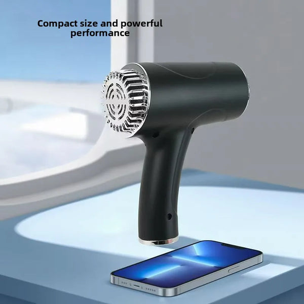 Un sèche-cheveux professionnel sans fil noir à côté d'un smartphone.