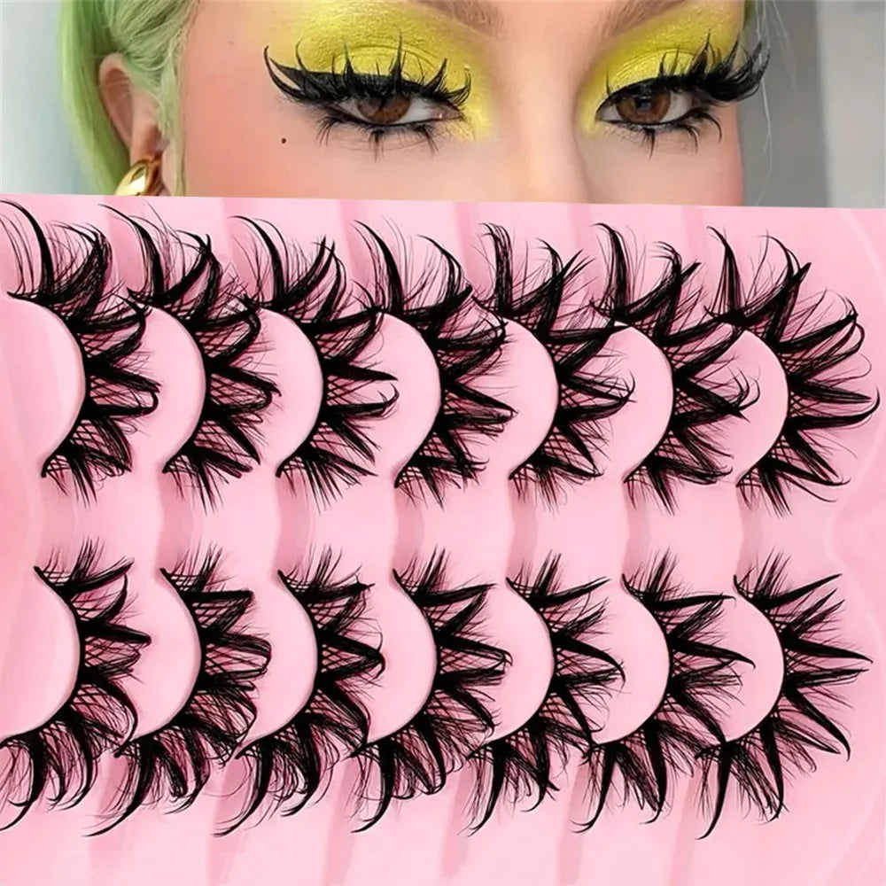 Close-up of a model wearing bold, voluminous black false eyelashes on her eyes.