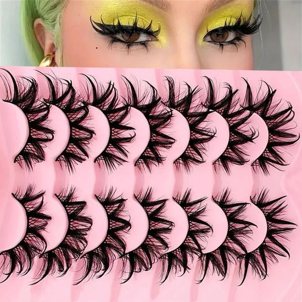 Close-up of a model wearing bold, voluminous black false eyelashes on her eyes.