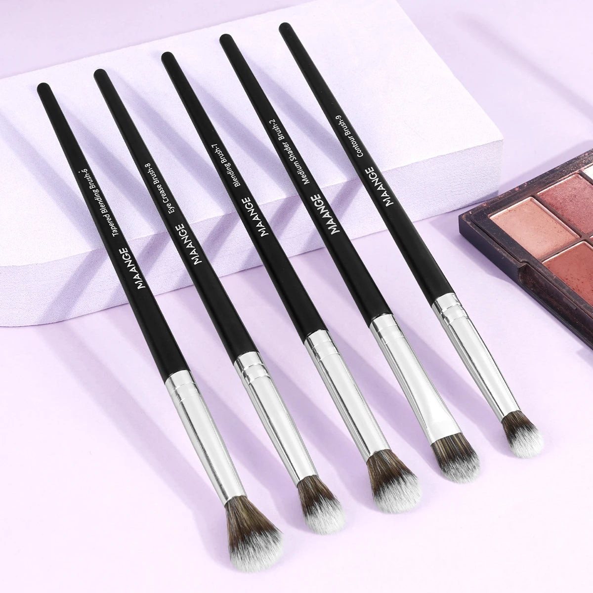 A set of nine precision makeup brushes in various sizes and shades displayed on a white box.