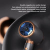 A close-up view of a black hair dryer with a round blue light feature and a gold accent, shown in use.