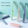A set of flexible folding hairbrushes in various shades of green and purple are displayed on a white surface.