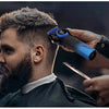 A man is using a professional rotary hair trimmer with an adjustable blade on his haircut.
