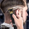 A hand uses a professional hair clipper to create a fade haircut on a man's side.