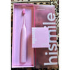 A pink electric toothbrush and its packaging box are displayed on a patterned surface.