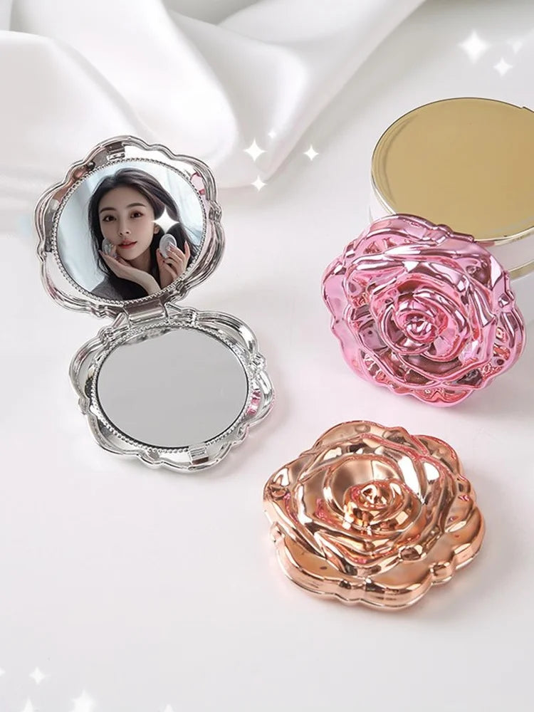 A vintage rose design double-sided pocket makeup mirror with a pink rose and gold accents.