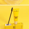 A tube of yellow eyebrow gel is shown next to its packaging on a yellow background.