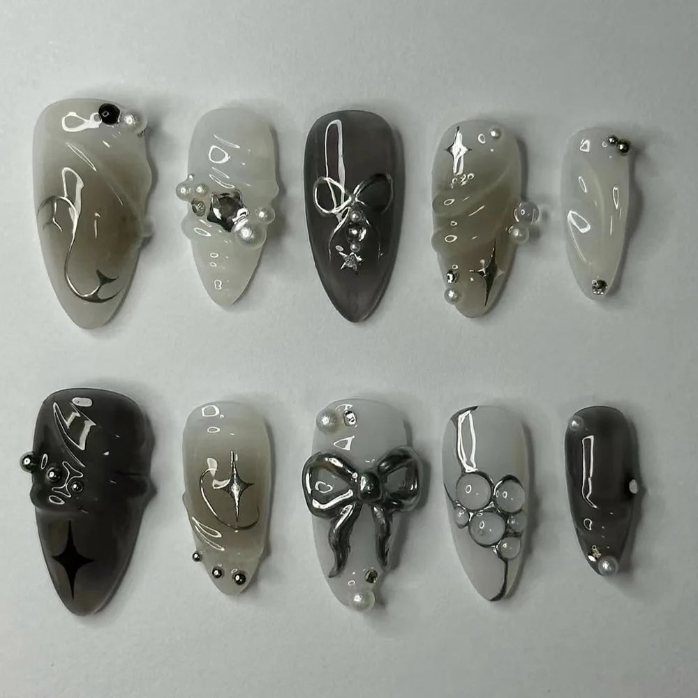 A collection of 24 press-on fake nails featuring a pink heart design and pearl embellishments.