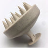 A beige wet and dry scalp massage brush with pointed bristles shown from the side.
