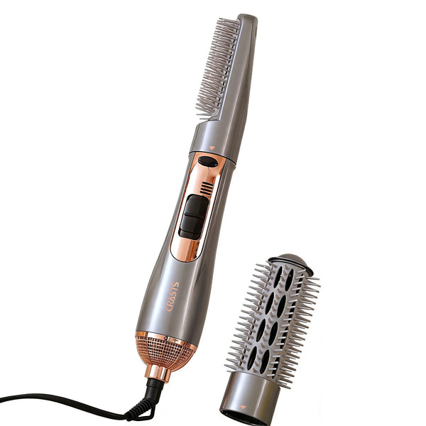 A silver hot air styling comb with a flexible attachment is shown against a white background.