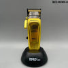 A gold and black electric hair clipper with a digital brushless motor mounted on a base.
