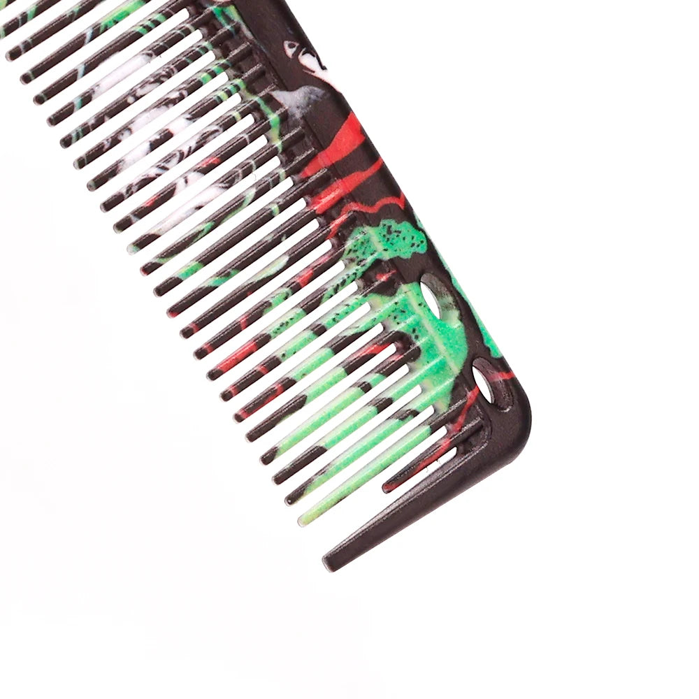 A close-up view of a black beard styling brush with green and red accents, showing the teeth and handle.