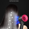 A black bladeless hair dryer is shown directing negative ions onto long, dark hair.