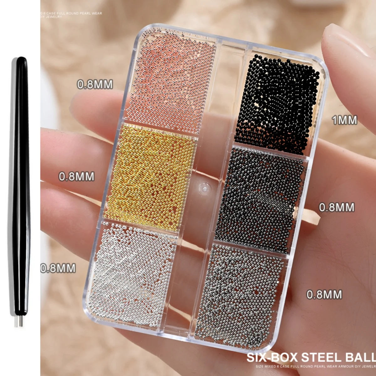 A clear box of six different shades of gold mixed stainless steel beads for nail art decorations