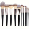 A set of various makeup brushes with natural hair and dark handles.