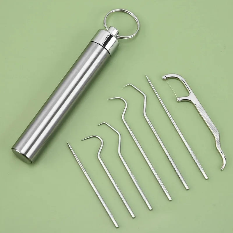 Un cure-dent et un kit de dentifrice avec boucle en acier inoxydable, présentés sur fond vert.