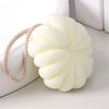 A white exfoliating bath bubble ball with a soft mesh sponge attached to a natural fiber cord.