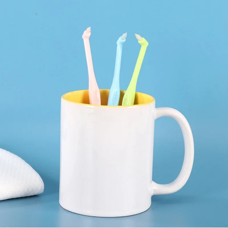 A white mug holds a set of five colored precision interdental toothbrushes.