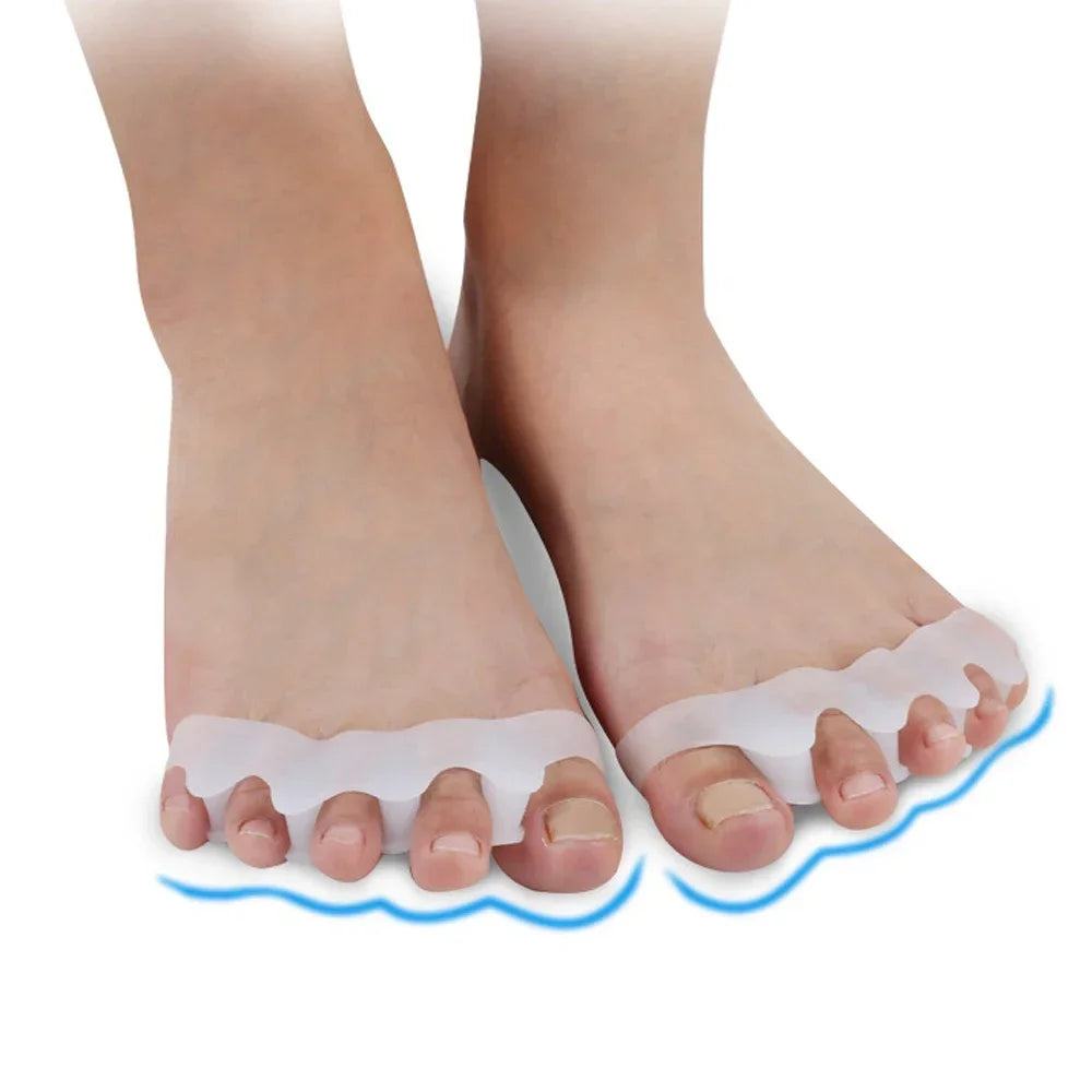 Pair of clear soft gel toe separators placed on the soles of two feet.