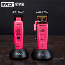 Two pink cordless hair clippers, one T-blade and one 2.0 cutting blade, displayed on a dark wooden surface.